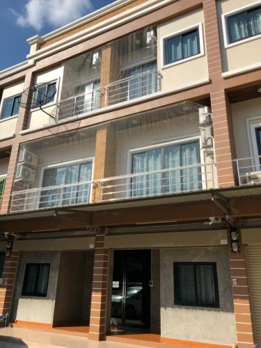 an apartment building with balconies on the side of it at Rabbit Hotel in Phetchabun