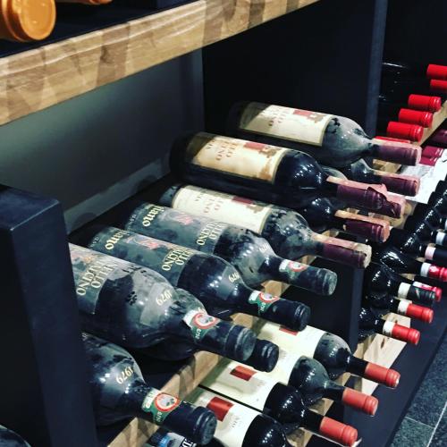 a bunch of wine bottles in a wine cellar at Locanda Giustini in Assisi