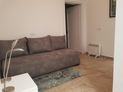 a brown couch sitting in a living room at Lux Apartment in Belgrade 2 in Belgrade
