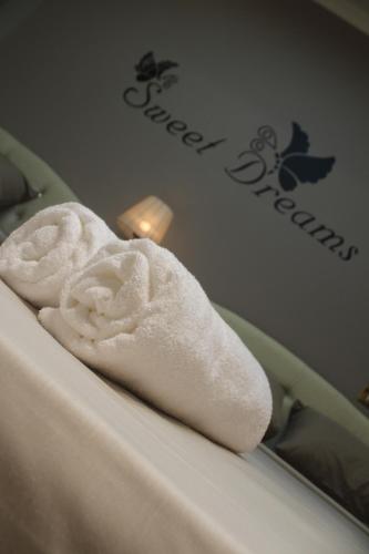 a white towel sitting on top of a bed at Tahrir Square Hostel in Cairo