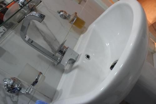 a white sink with a faucet in a bathroom at Tahrir Square Hostel in Cairo