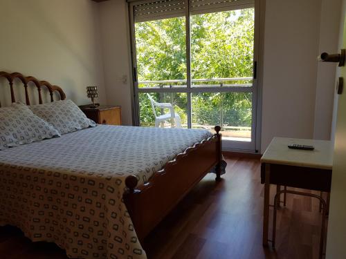 a bedroom with a bed and a large window at Plaza López in Rosario