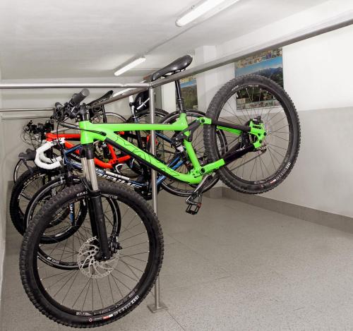two bikes hanging on a rack in a room at Pension Sattlerenglhof in Laces