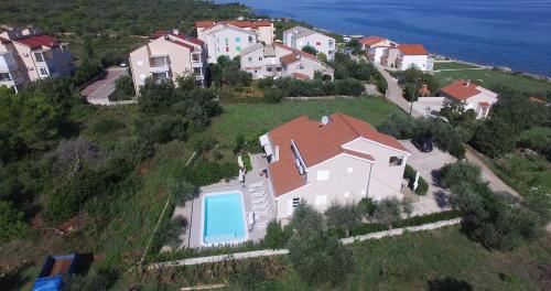 an aerial view of a house on a hill with a swimming pool at Apartmani Vila Karla, Dobropoljana, otok Pašman in Dobropoljana