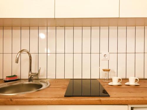 a kitchen with a sink and two cups on a counter at VISTA Gudauri - White decision in Gudauri