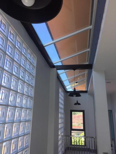 a hallway with a skylight in a building at บ้านรวมสุข the Happiness in Chiang Kham
