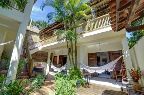 a house with hammocks in the courtyard at Pousada Campestre in Trancoso