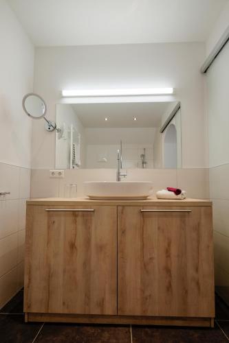 a bathroom with a sink and a mirror at Aktiv Hotel Karnia in Hermagor