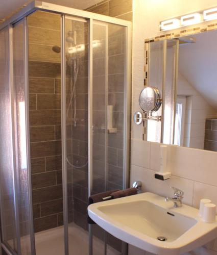 a bathroom with a shower and a sink at Pension Bavaria in Mittenwald
