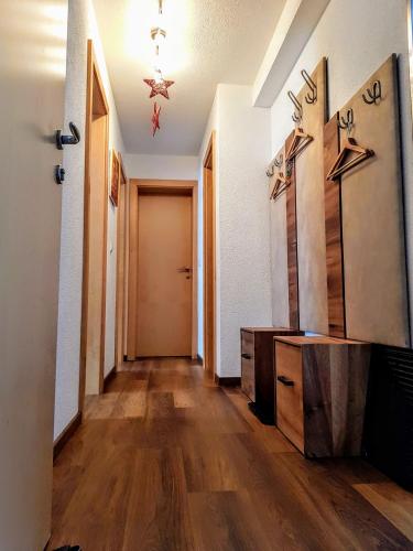 a hallway with wooden floors and a room with a door at Ferienhaus Gundi in Pettneu am Arlberg
