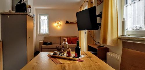 a living room with a table with wine bottles on it at Ferienhaus Gundi in Pettneu am Arlberg