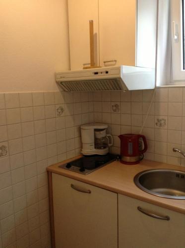 a kitchen with a sink and a counter top at Gästehaus Renate in Velden am Wörthersee