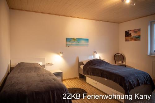 a bedroom with two beds and a window at Ferienwohnung Kany in Bliesmengen-Bolchen
