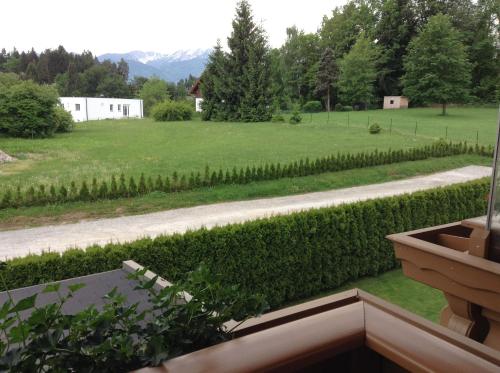 a view of a garden from the balcony of a house at Gästehaus Renate in Velden am Wörthersee