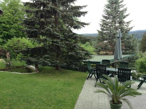 a patio with a table and an umbrella at Gästehaus Renate in Velden am Wörthersee