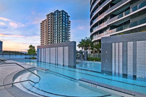 a large swimming pool next to a tall building at Luxury 3 Bedroom in heart of Broadbeach in Gold Coast