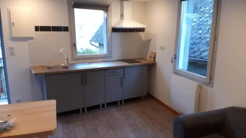 a small kitchen with a sink and a window at Chez Papy et Mamie in Aubazines