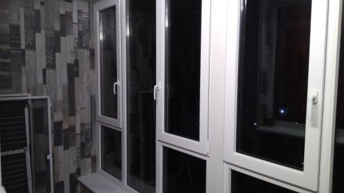 a pair of glass doors in a bathroom at Apartment Danchehko 3b in Chornomorsk