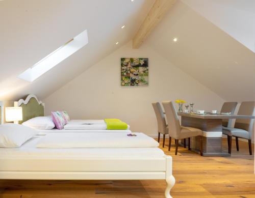 a bedroom with two beds and a dining table at Appartements-Dalila in Sankt Michael im Lungau