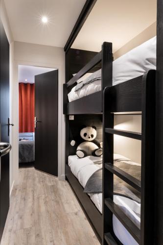 a bedroom with two bunk beds with a teddy bear at Résidences Alticimes in Brides-les-Bains