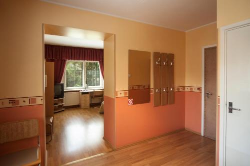 an empty room with an open door and a living room at Alexi Villa in Tallinn