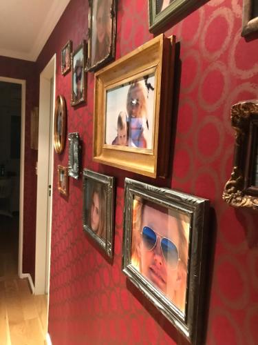 a bunch of pictures hanging on a wall at Avenida Las Heraas in Buenos Aires