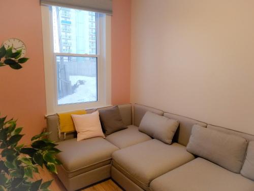 a living room with a couch and a window at Ottawa Stay Downtown Suites in Ottawa