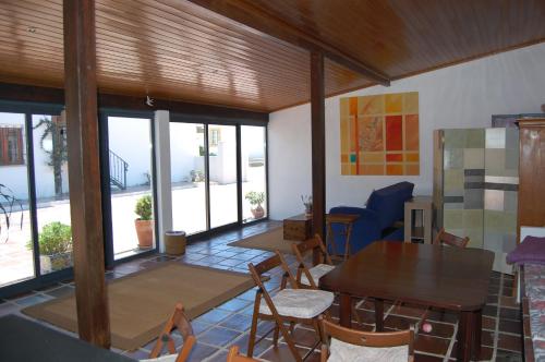 a dining room with tables and chairs and windows at Apartamentos Vale Da Varzea in Areia Branca