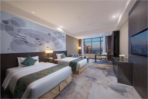 Postel nebo postele na pokoji v ubytování Shenyang Huaqiang Novlion Hotel