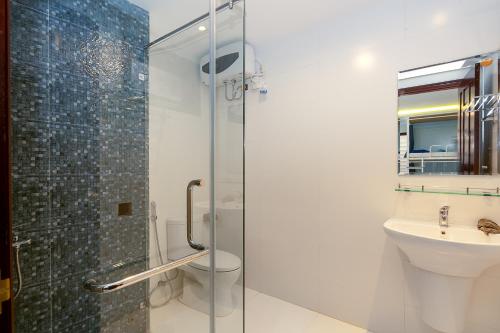 a bathroom with a shower and a toilet and a sink at Siro House Da Nang Homestay in Da Nang