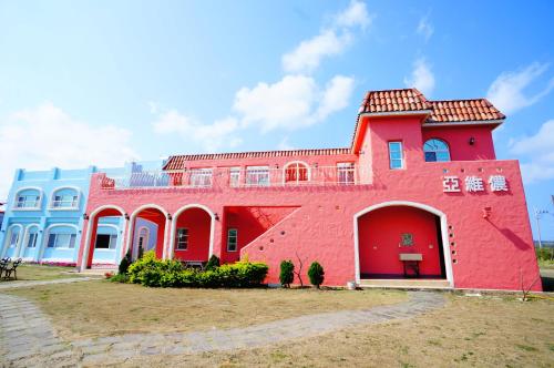 a red brick building with a redventh floor at Kenting Avignon in Hengchun South Gate