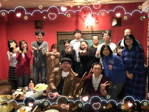a group of people posing for a picture in a room at HappyCloset&WasamonHostel in Kumamoto