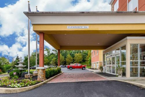 a red car parked in front of a building at Comfort Suites Near Gettysburg Battlefield Visitor Center in Gettysburg
