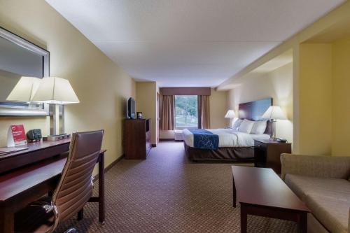 a hotel room with a bed and a living room at Comfort Suites Near Gettysburg Battlefield Visitor Center in Gettysburg