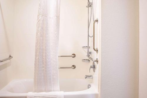 a shower with a white shower curtain in a bathroom at Comfort Inn & Suites Niagara Falls Blvd USA in Niagara Falls