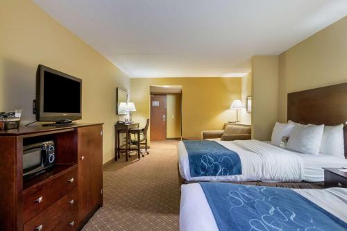 a hotel room with two beds and a flat screen tv at Comfort Suites Near Gettysburg Battlefield Visitor Center in Gettysburg