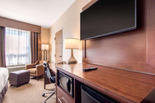 a hotel room with a large flat screen tv at Comfort Inn & Suites in Medicine Hat