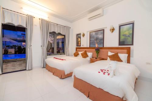 Ένα ή περισσότερα κρεβάτια σε δωμάτιο στο Hanh Nhung Villa