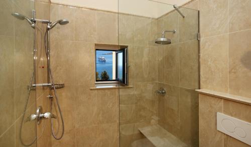 a bathroom with a shower with a window at Hotel Villa Belvedere in Taormina
