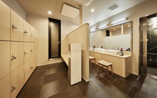 a bathroom with two sinks and a mirror at the square hotel KANAZAWA in Kanazawa