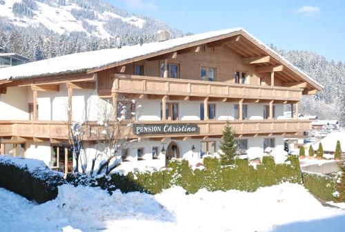 a large wooden building with snow on the ground at Sportpension Christina by PiaundDirk in Fügen