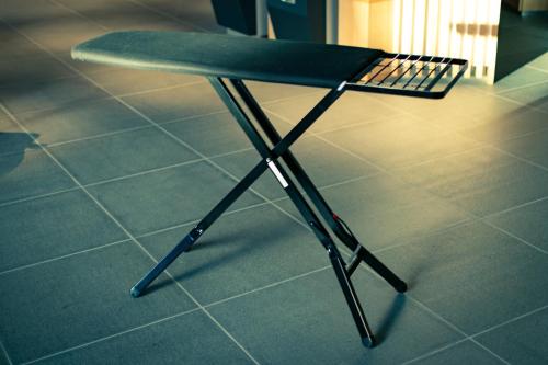 a ping pong table sitting on a tile floor at the square hotel KANAZAWA in Kanazawa