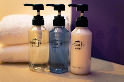 a group of three bottles sitting on a table at the square hotel KANAZAWA in Kanazawa