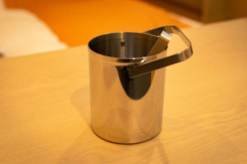 a metal trash can sitting on top of a table at the square hotel KANAZAWA in Kanazawa