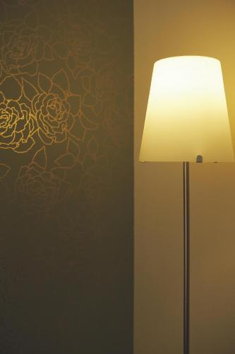 a lamp with a flower pattern on a wall at Rotonda Hotel in Thessaloniki