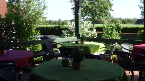 a table with a green table cloth on a patio at Hotel Marianne und Restaurant Kiek In in Plau am See