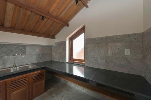 a large kitchen with a sink and a window at An Bang Beach Villa in Hoi An