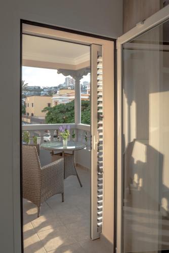 an open door to a balcony with a table at La Palmera Hotel Boutique in Las Palmas de Gran Canaria