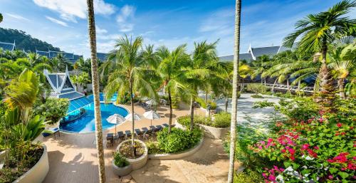 an aerial view of a resort with a pool and palm trees at Chada Thai Village in Ao Nang Beach