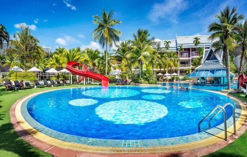 a pool at the resort with a slide at Chada Thai Village in Ao Nang Beach